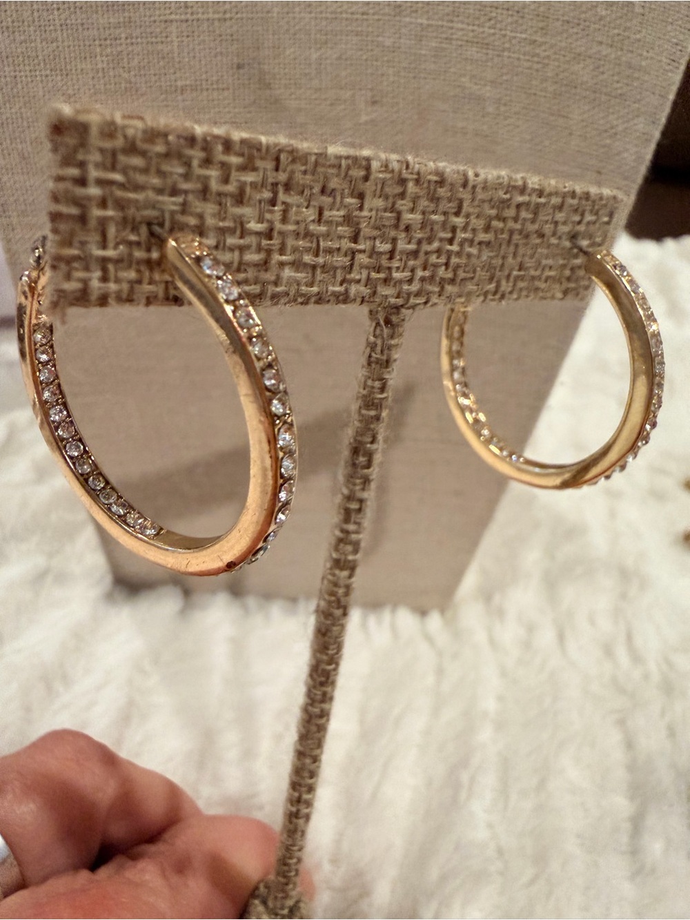 Golden hoop earrings with embedded rhinestones